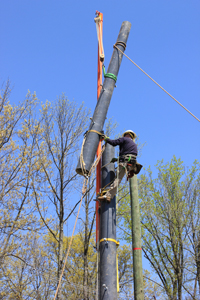 An RS PowerON composite pole is being installed using a PowerON gin pole