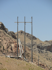 Installed composite utility poles in an off-road, mountainside location