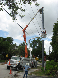A composite utility pole is being installed vertically on a roadside, while minimal space is required on the raodway