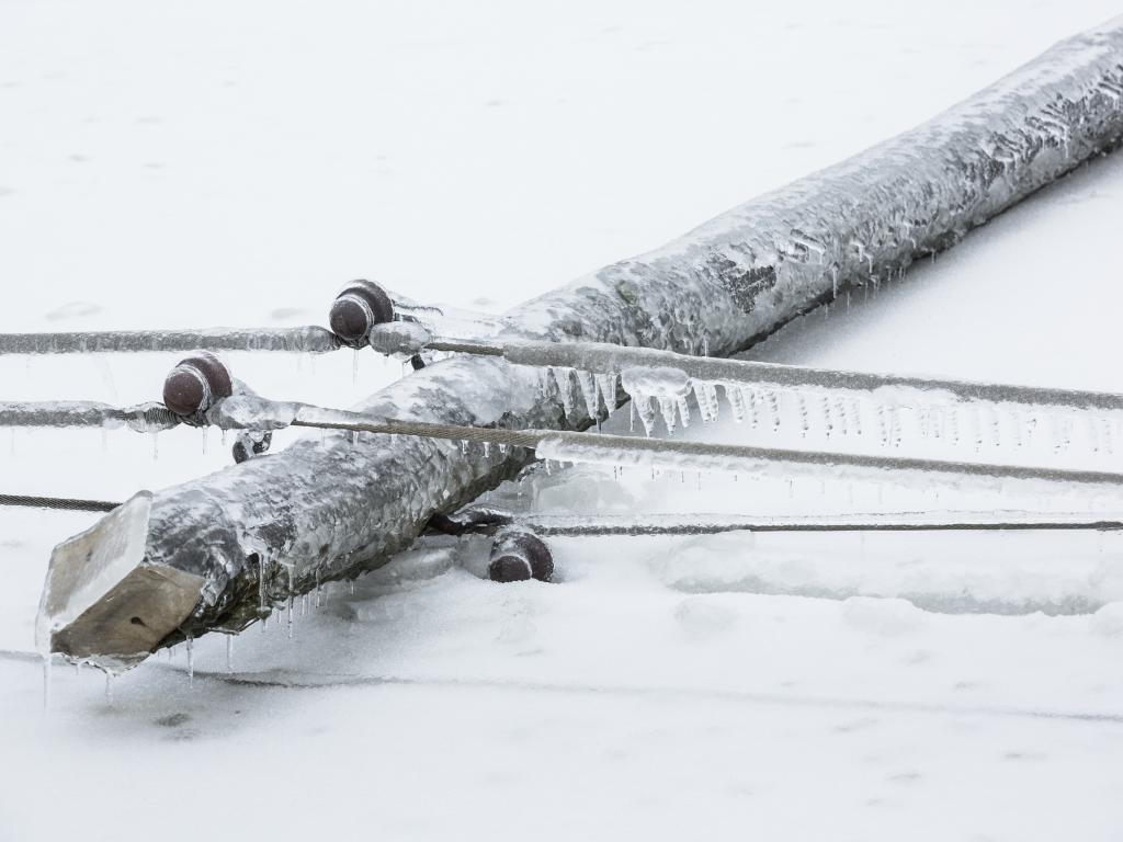 A wood utility has collapsed to the ground in a severe ice storm