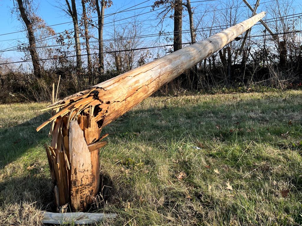 Broken wooden utility pole in the aftermath of a tornado